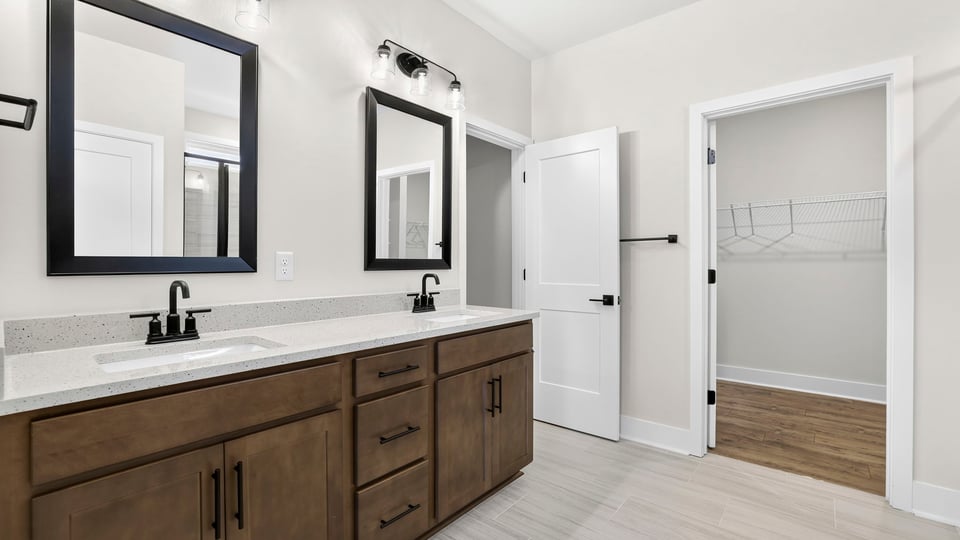 Bathroom with double vanity sink and closet.