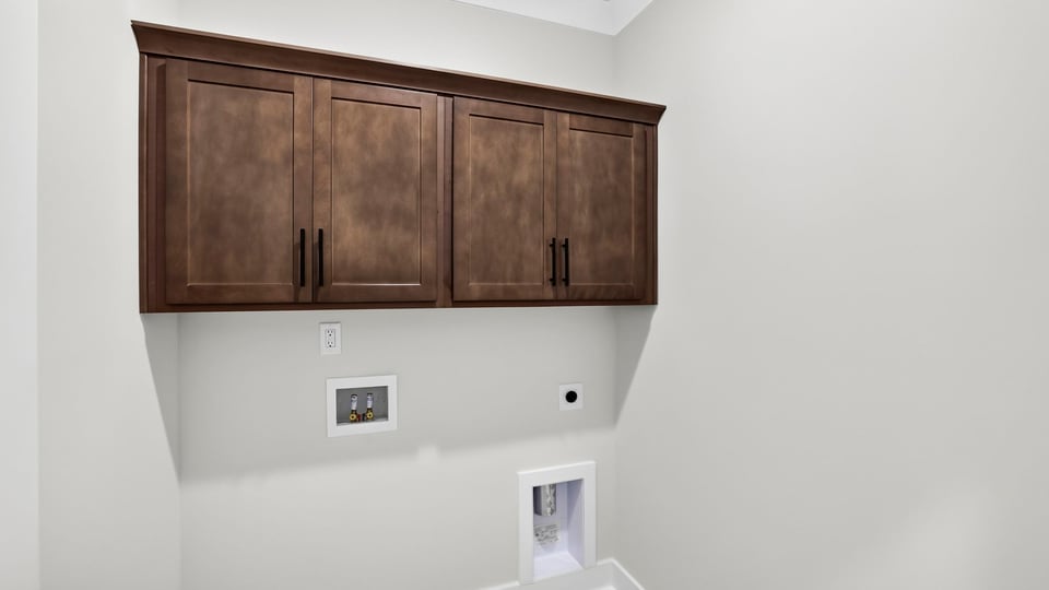 Laundry room with hanging storage racks.