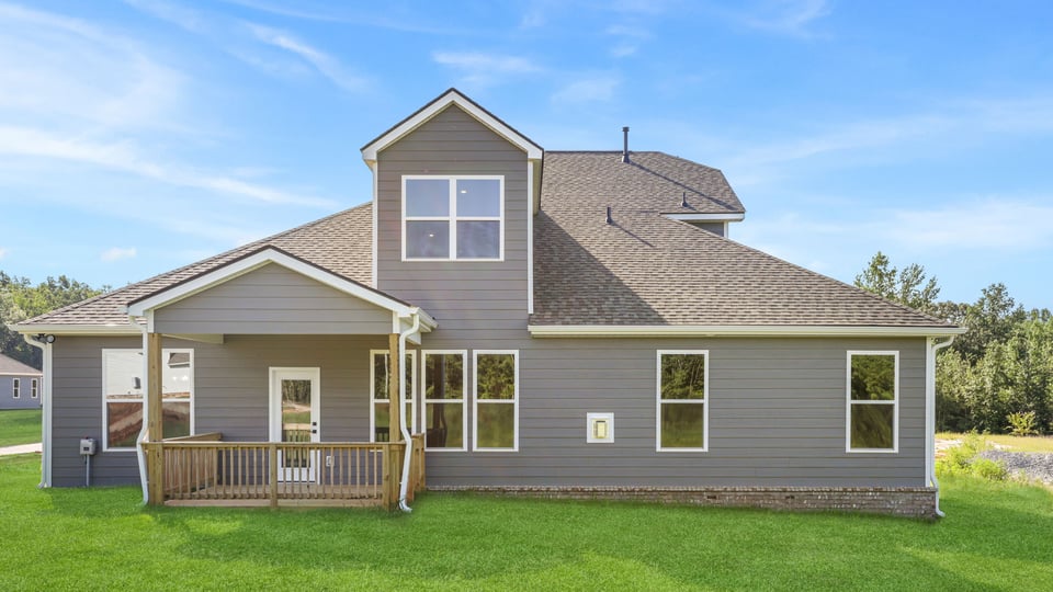 Back exterior of home with large backyard.