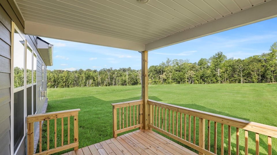 Back exterior of home with covered patio.