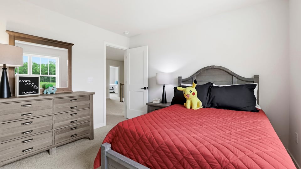 Bedroom with carpet and window.