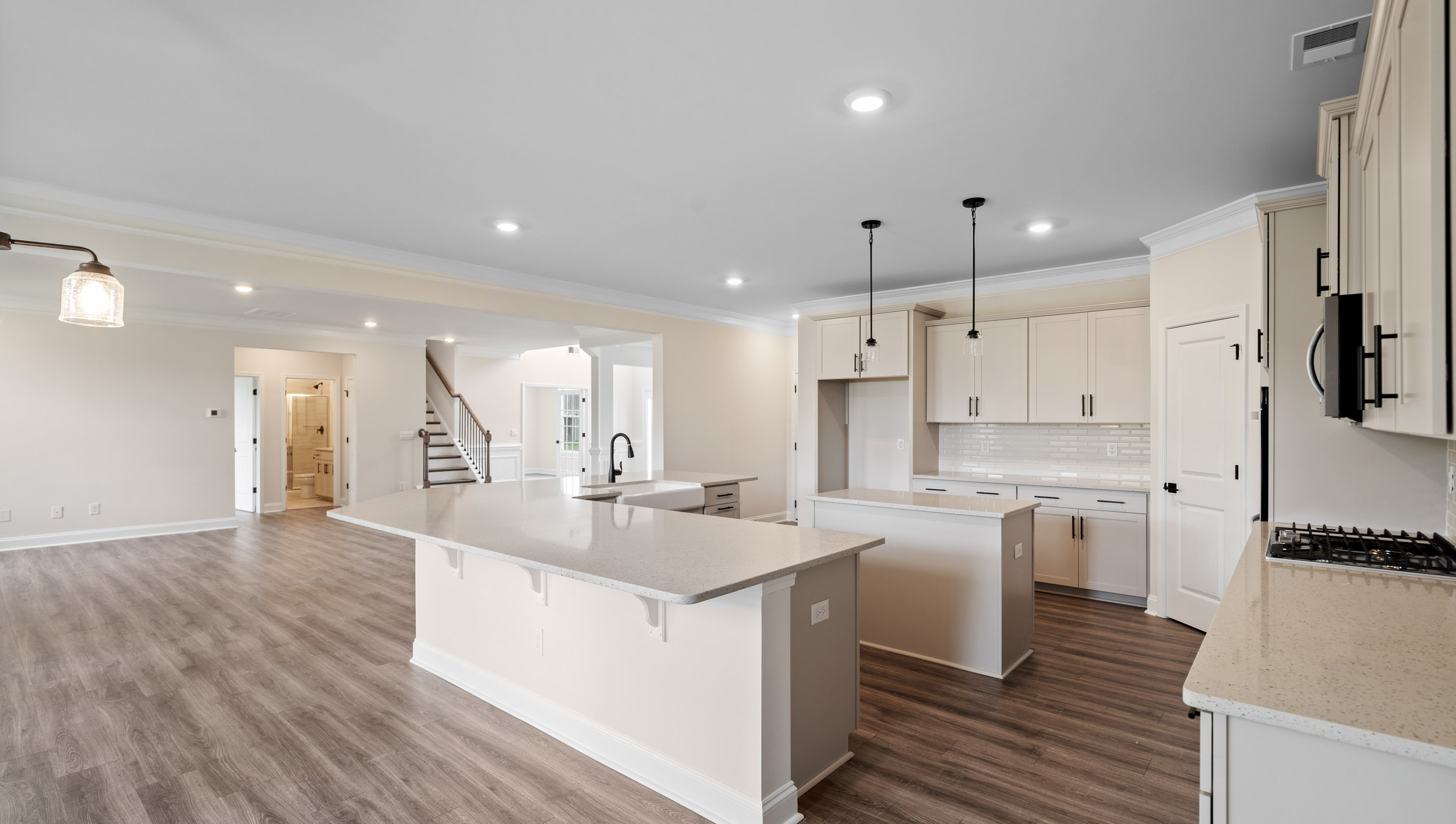 Kitchen with pendulum and recessed lighting.