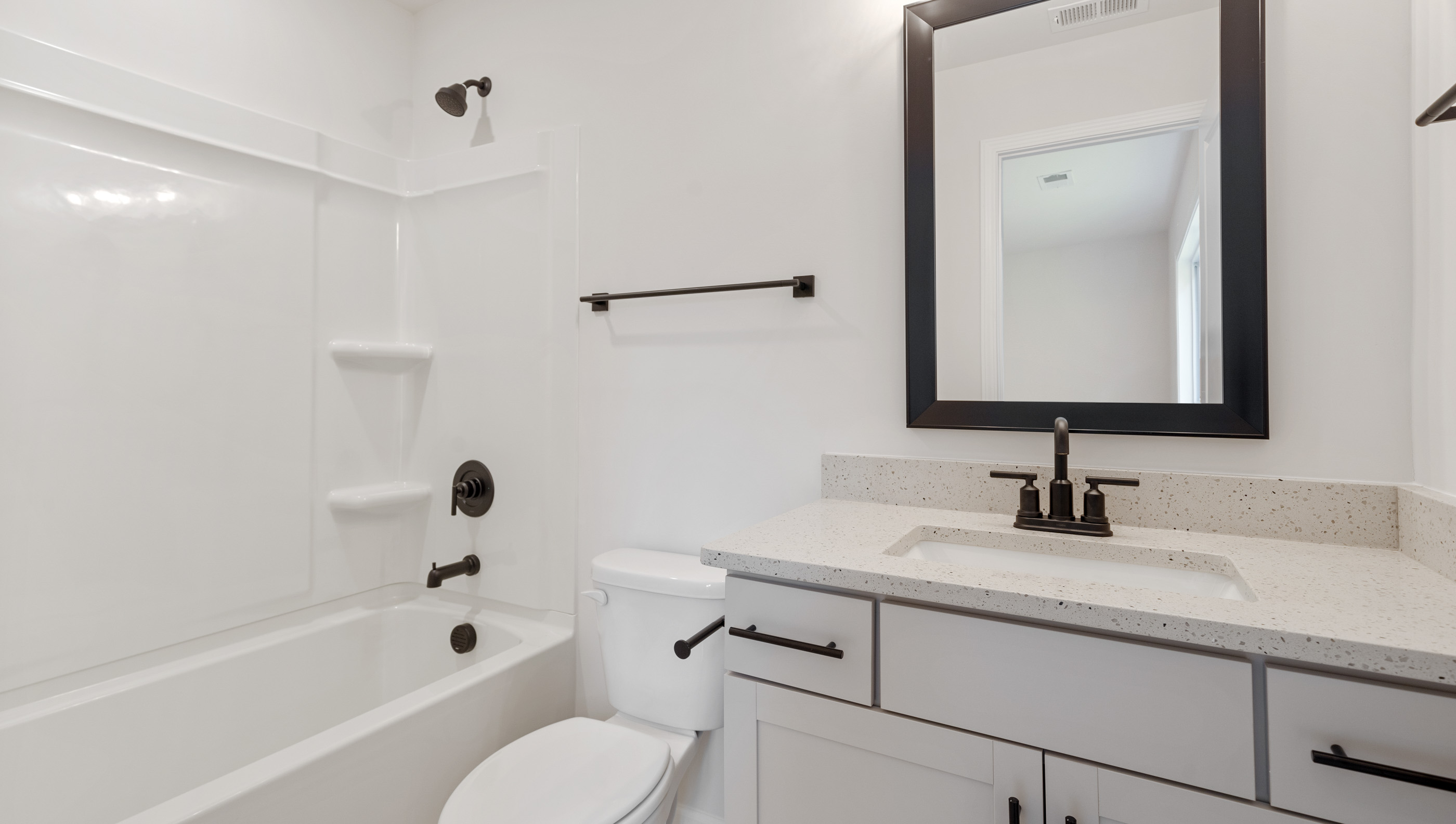 Hall bathroom with combination shower / tub.