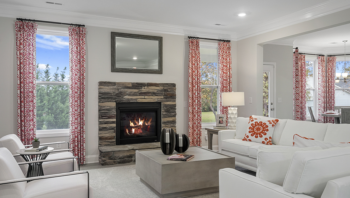 Living area with fireplace and windows.