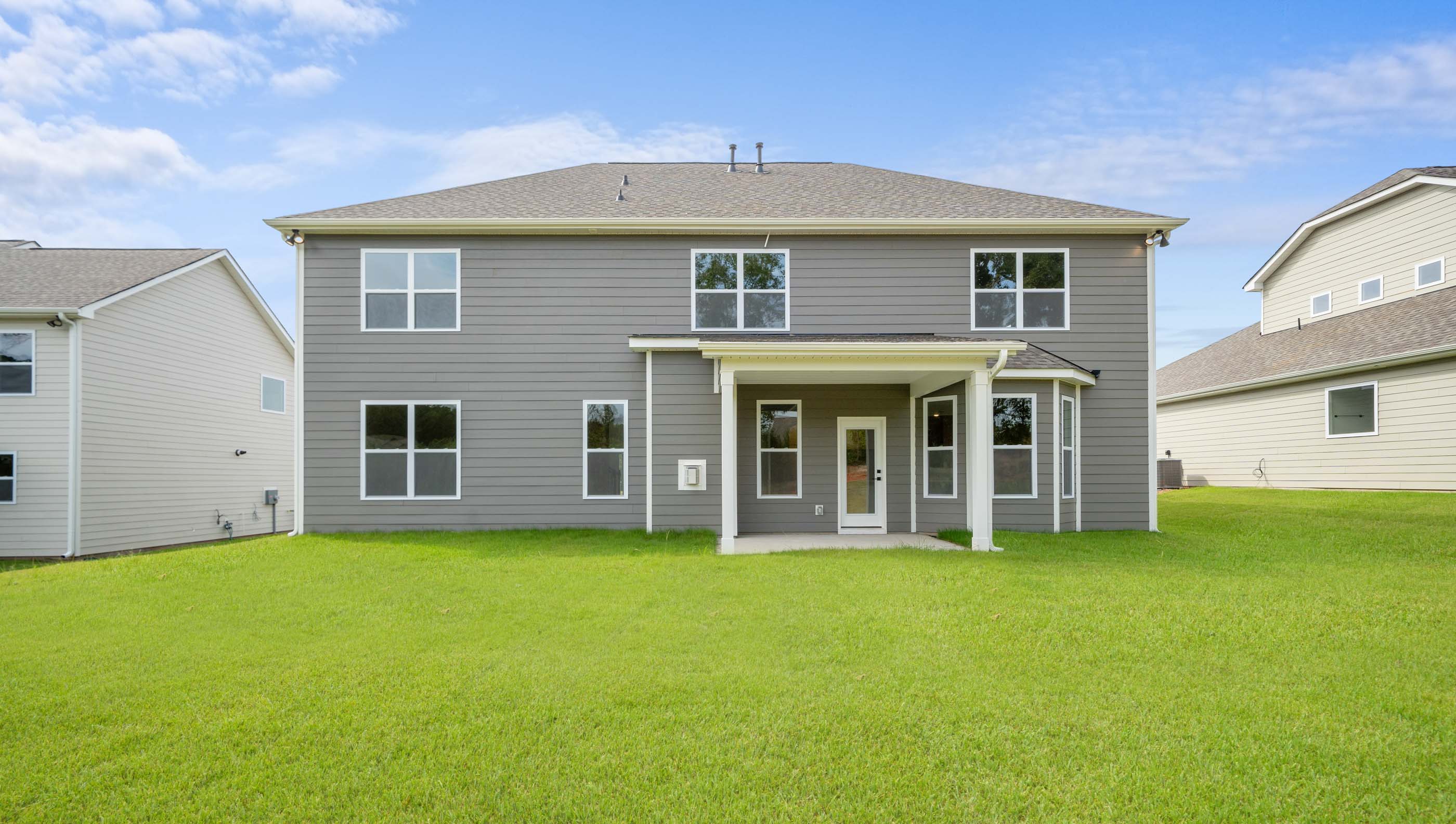 Back exterior with large backyard.