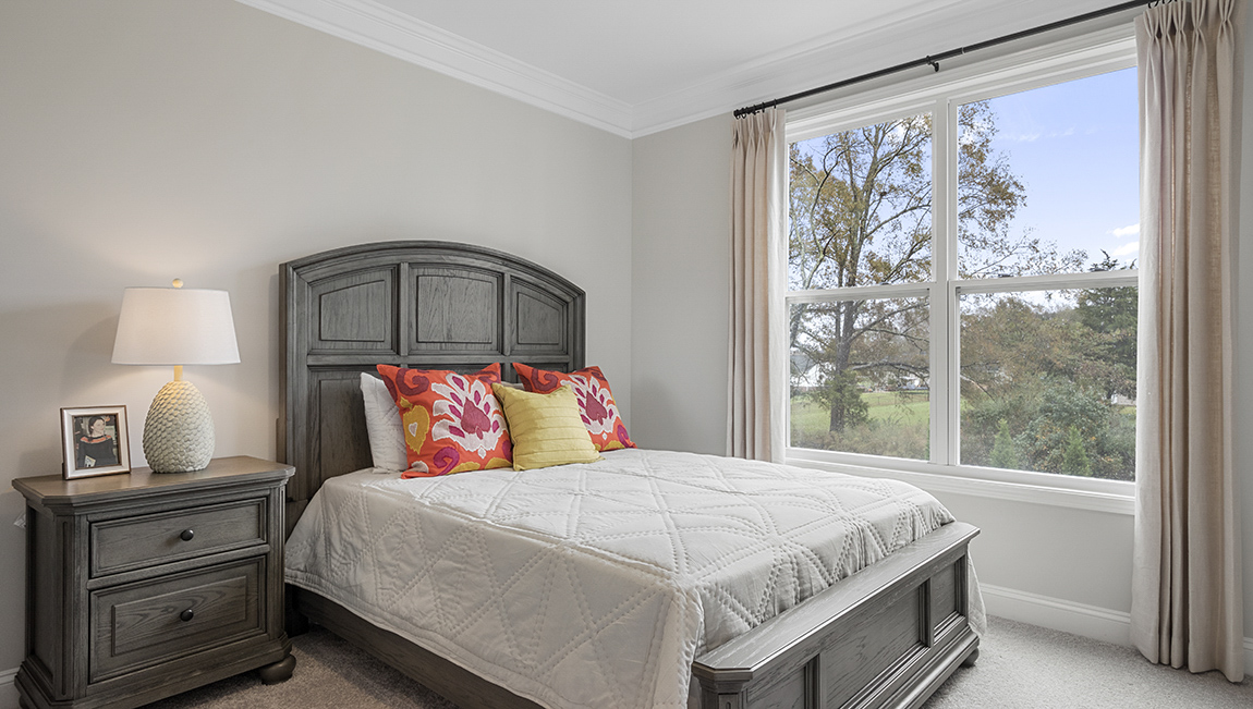 Bedroom with carpet and window.
