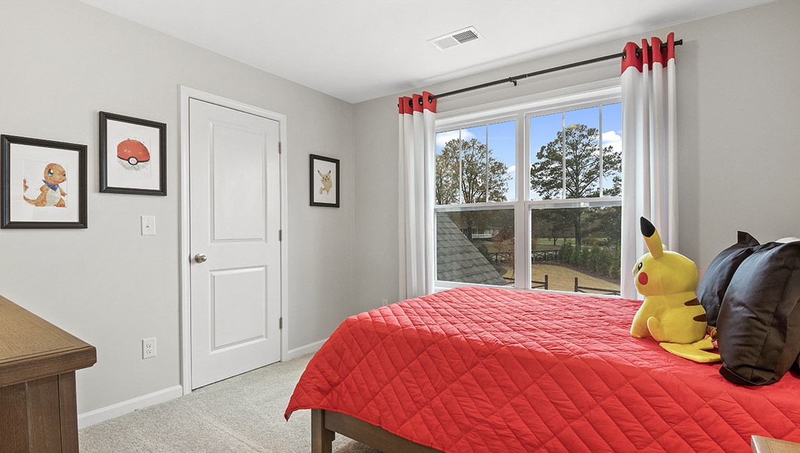 Bedroom with carpet and window.
