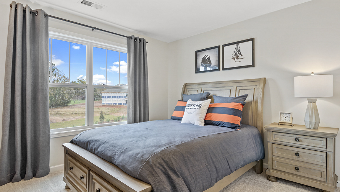 Bedroom with carpet and window.