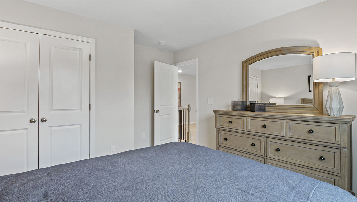 Bedroom with carpet and window.
