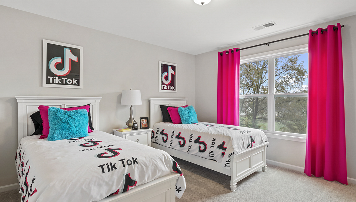 Bedroom with carpet and window.