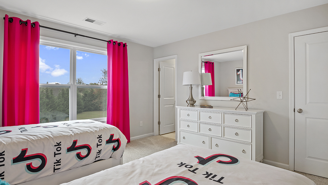 Bedroom with carpet and window.
