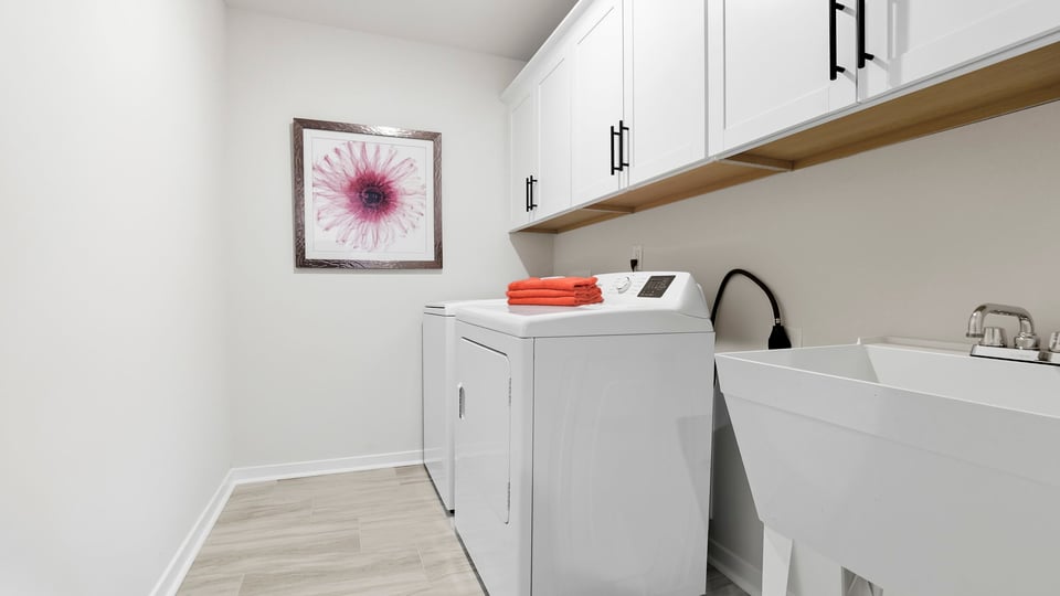 Laundry room with cabinets.