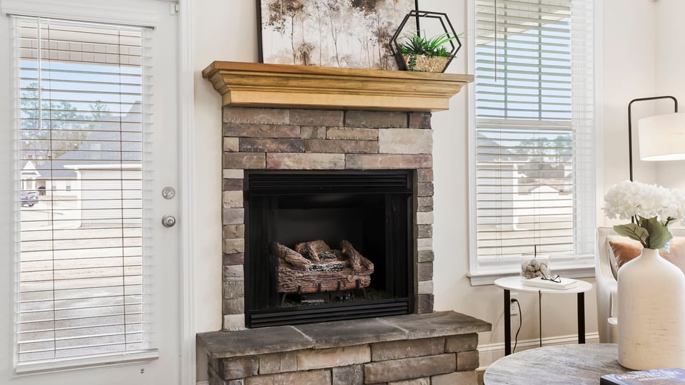 Living area with fireplace and windows.