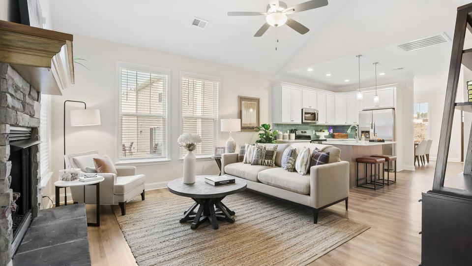 Living area with fireplace and windows.