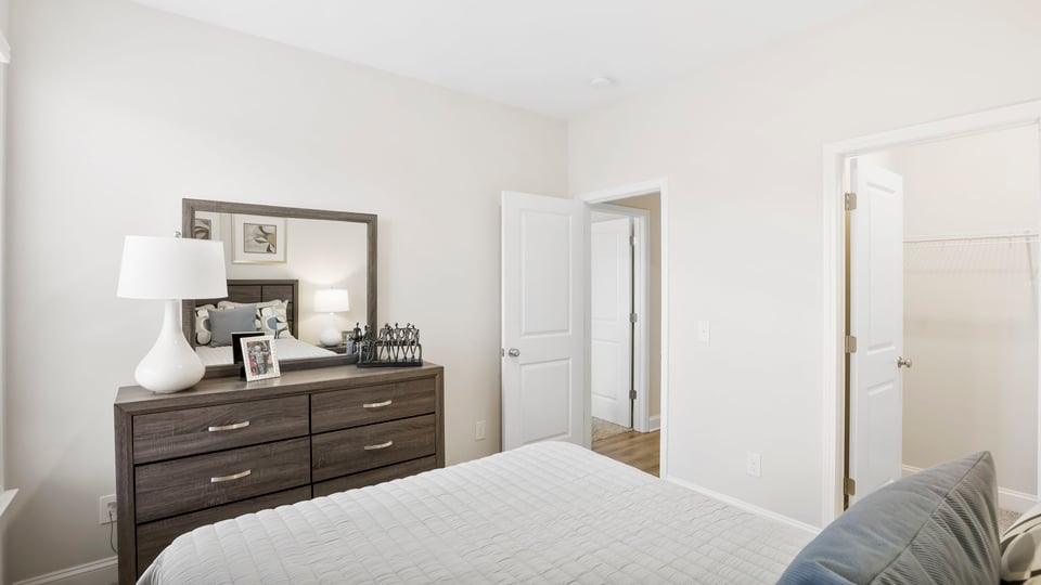 Bedroom with carpet and windows.