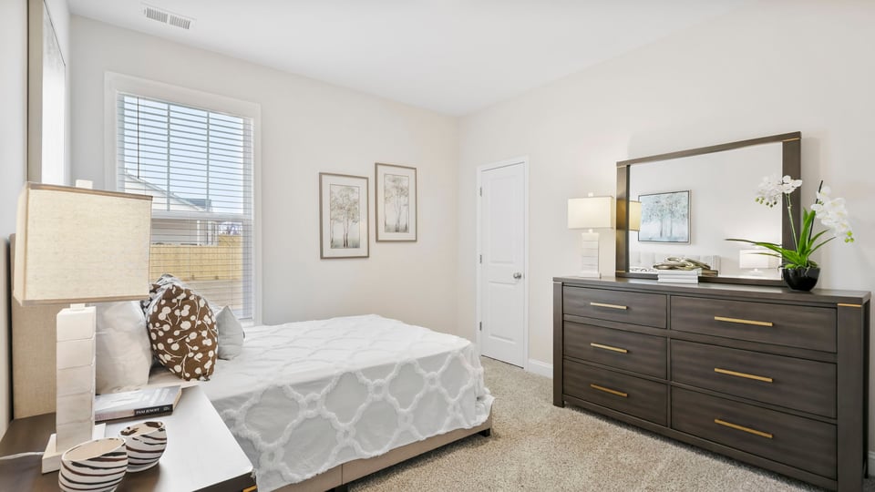 Bedroom with carpet and windows.