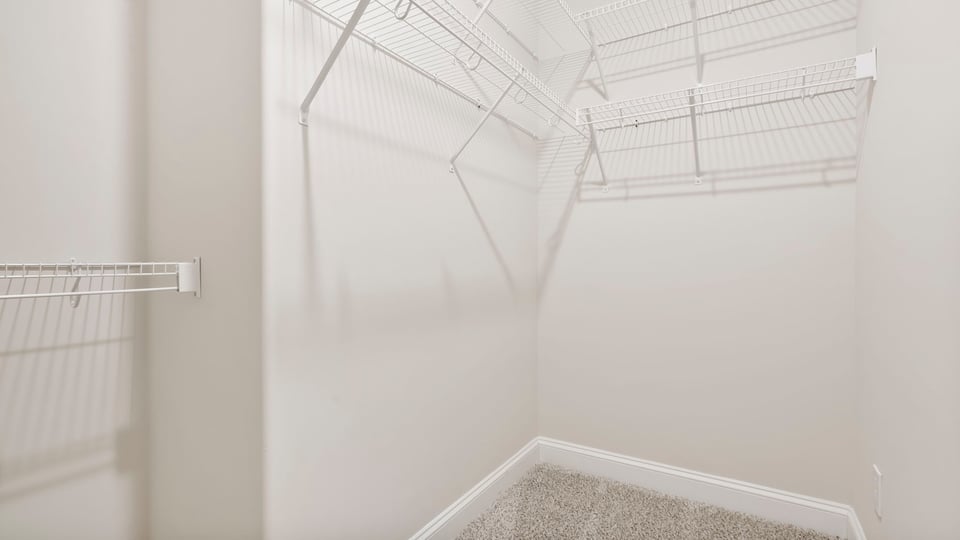 Primary closet with shelf.