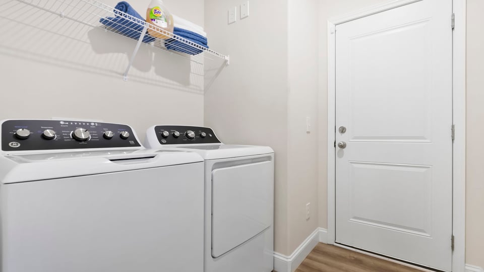 Laundry room with shelf.