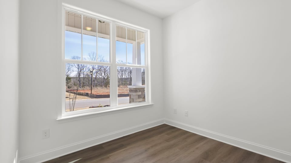 Study at front of home with large window.