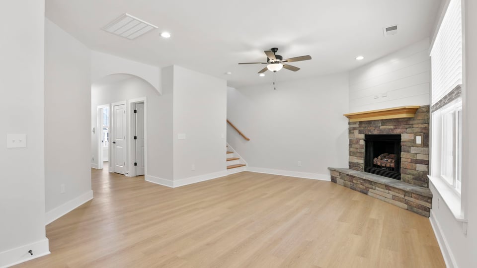 Living room with fireplace and windows.