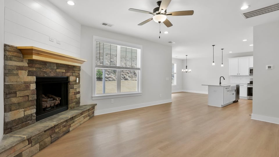 Living room with fireplace and windows.