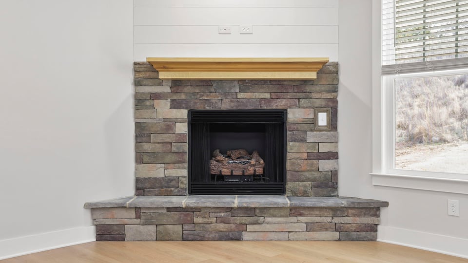 Living room with fireplace and windows.