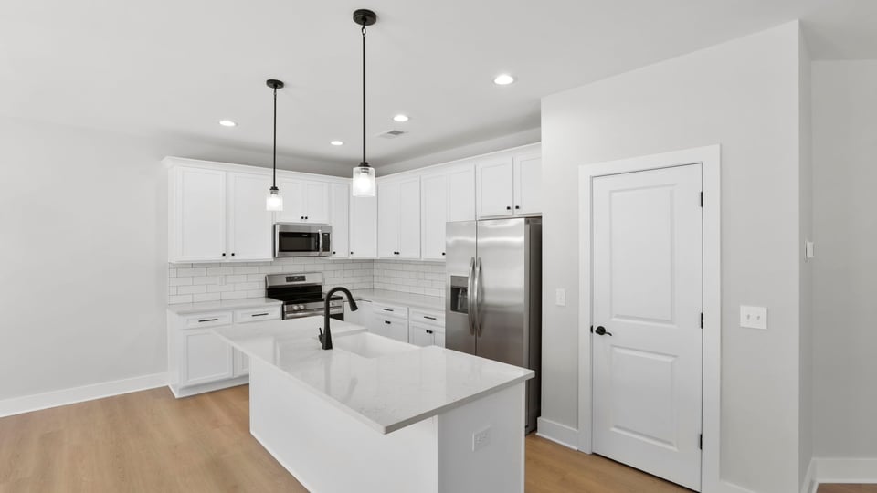 Kitchen with island and cabinets.