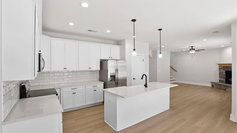 Kitchen with island and cabinets.