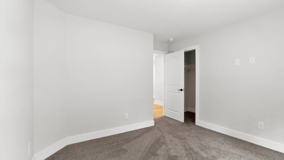 Bedroom with carpet and window.