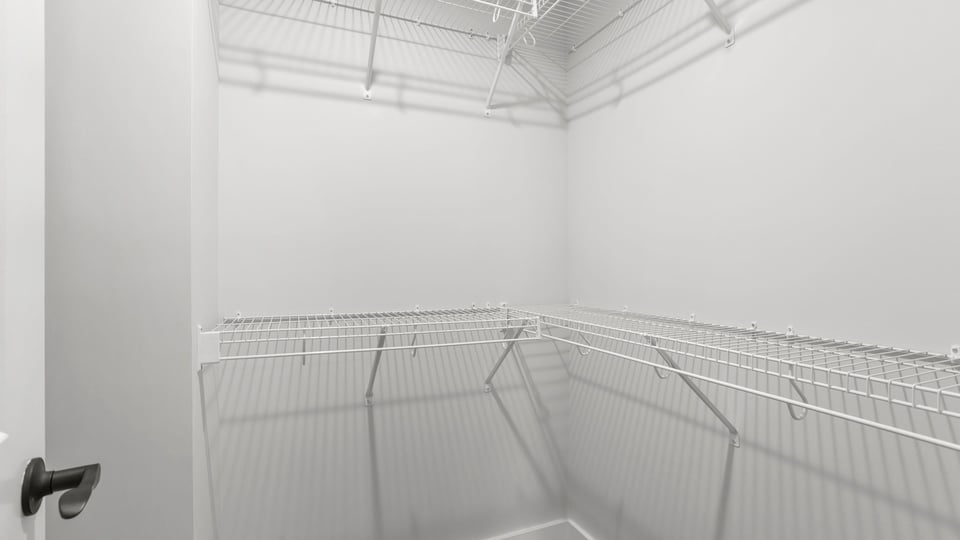 Primary closet with shelf.