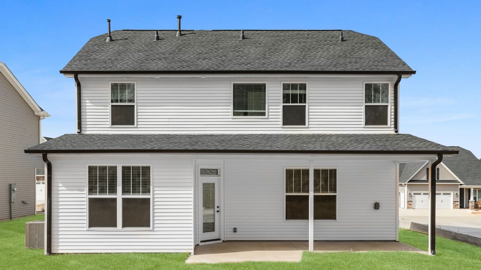 Back exterior with covered patio.