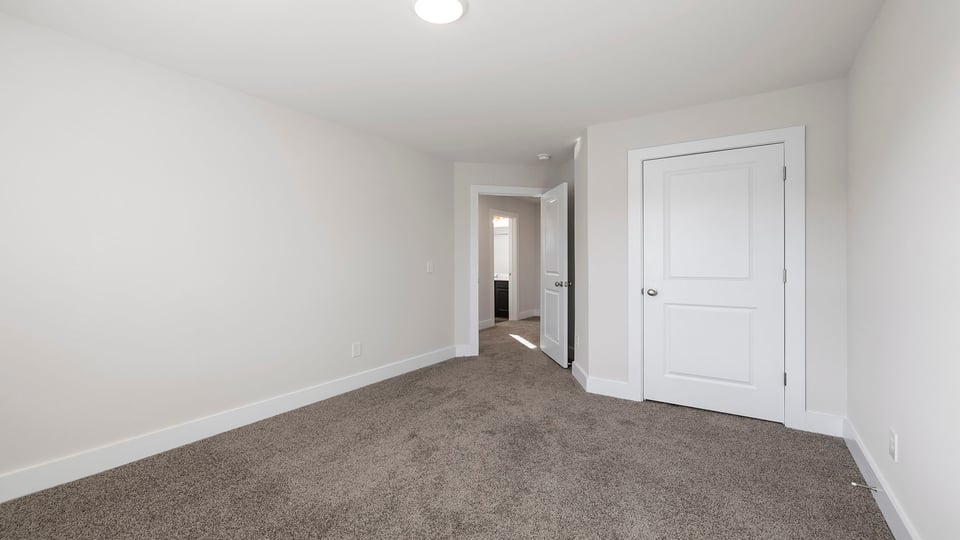 Bedroom with carpet and windows.