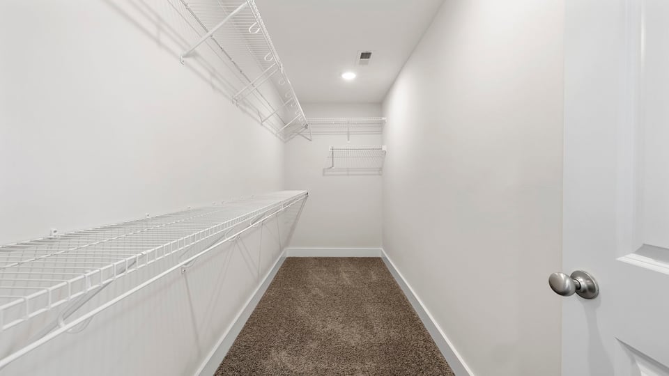 Primary closet with shelf.