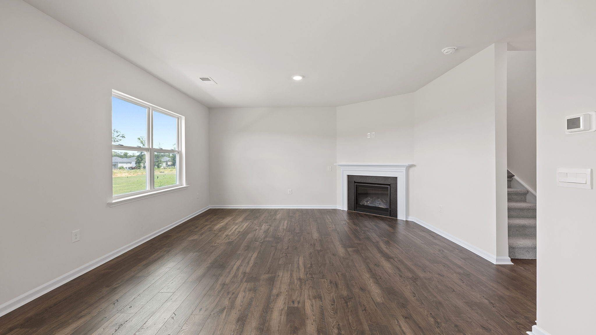 Living room with fireplace and windows.