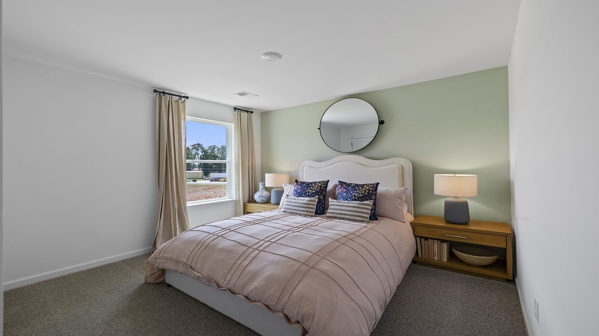 Bedroom with windows and carpet.