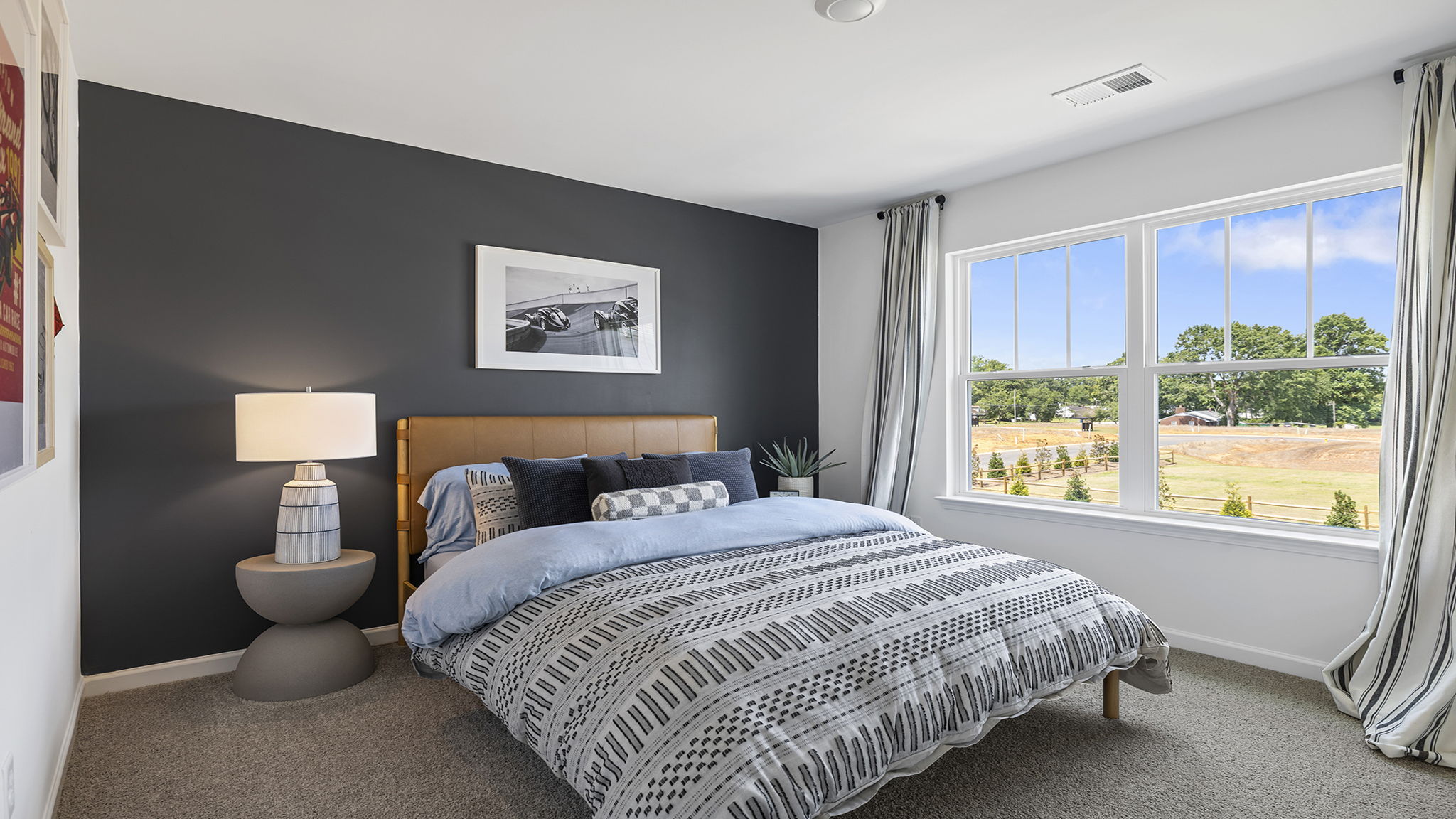 Bedroom with windows and carpet.