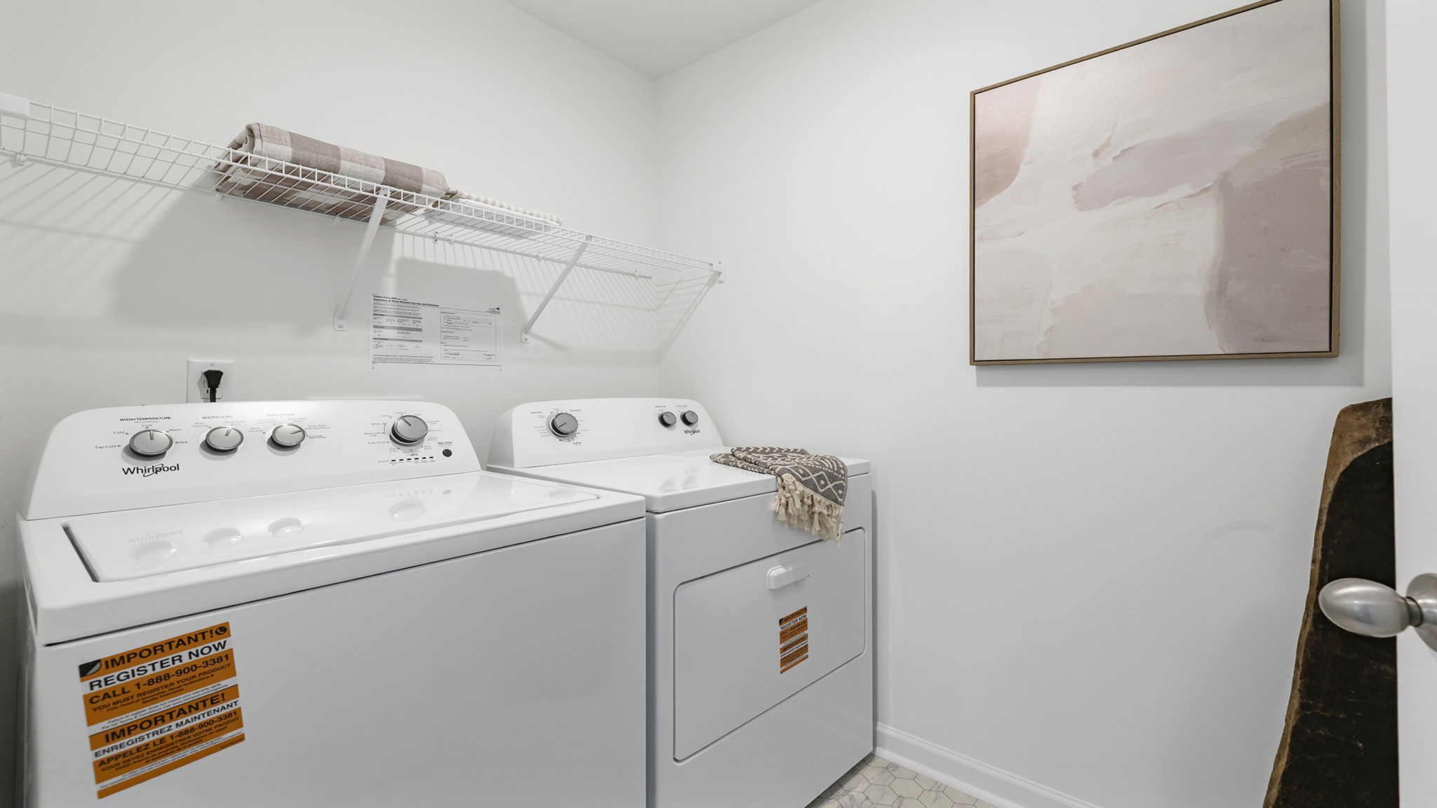 Primary laundry room with shelf.