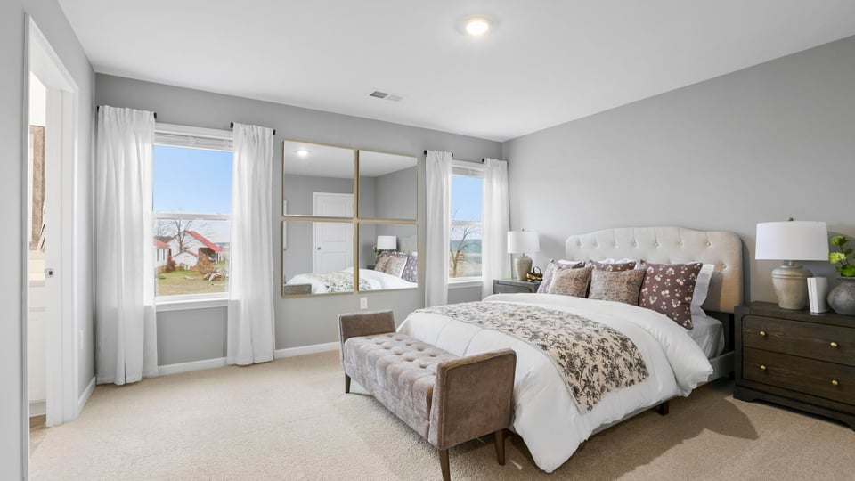 Bedroom with carpet and windows.