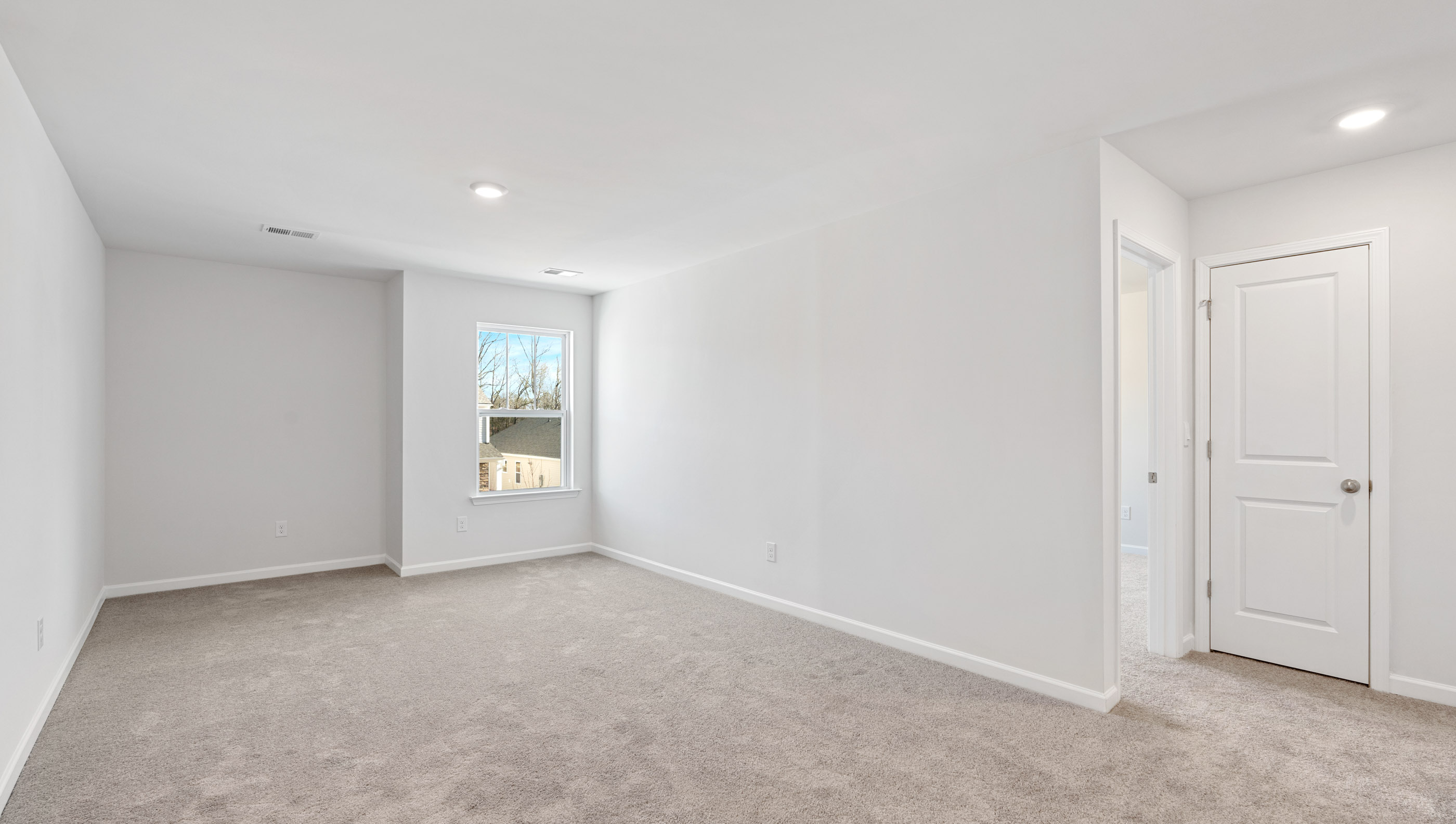 Bedroom with carpet and windows.