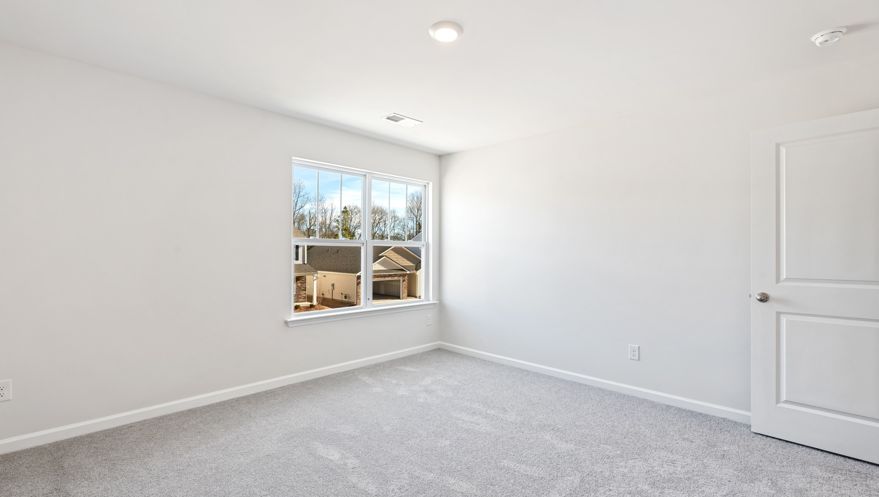 Bedroom with carpet and windows.