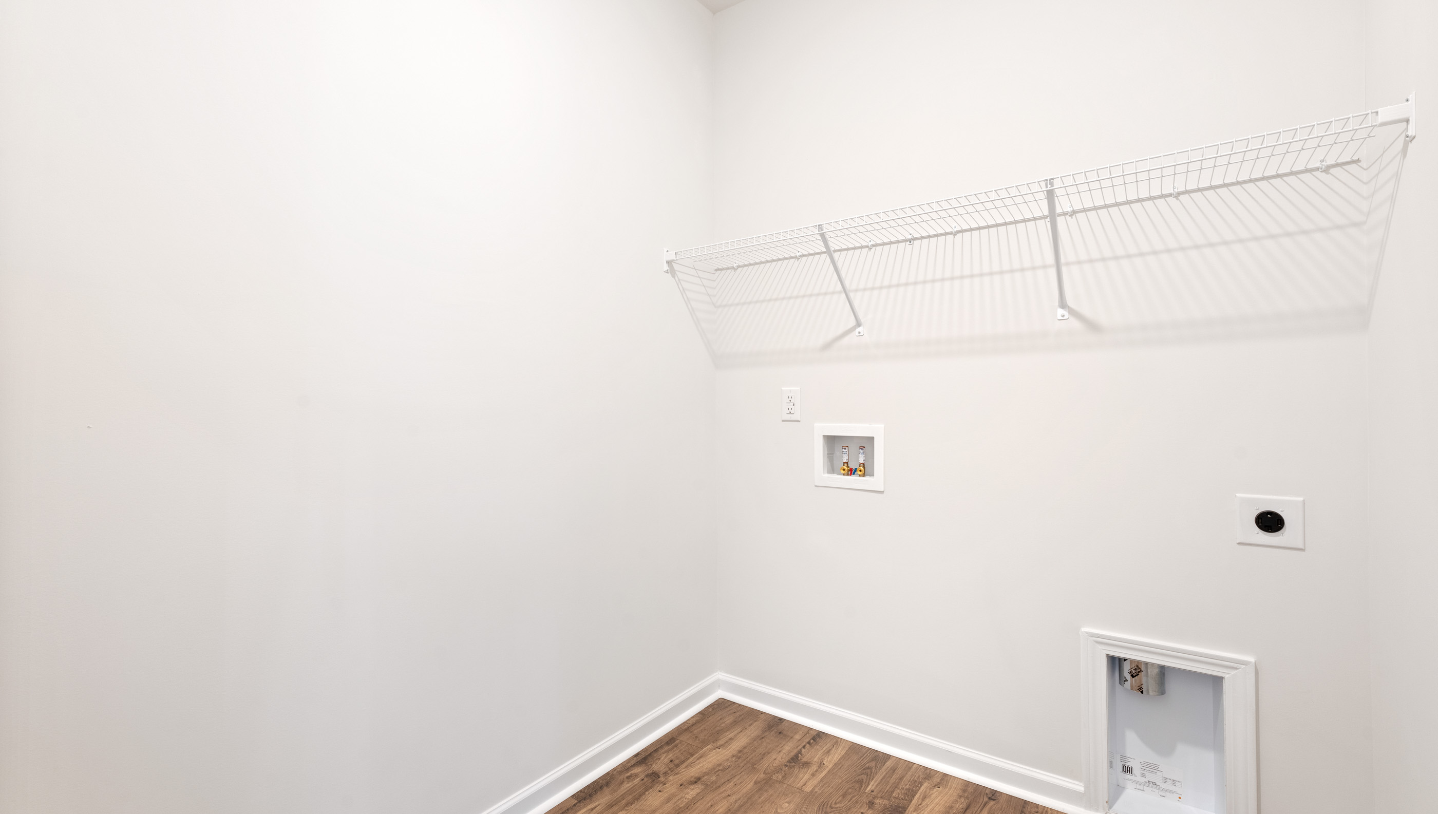 Laundry room with shelf.