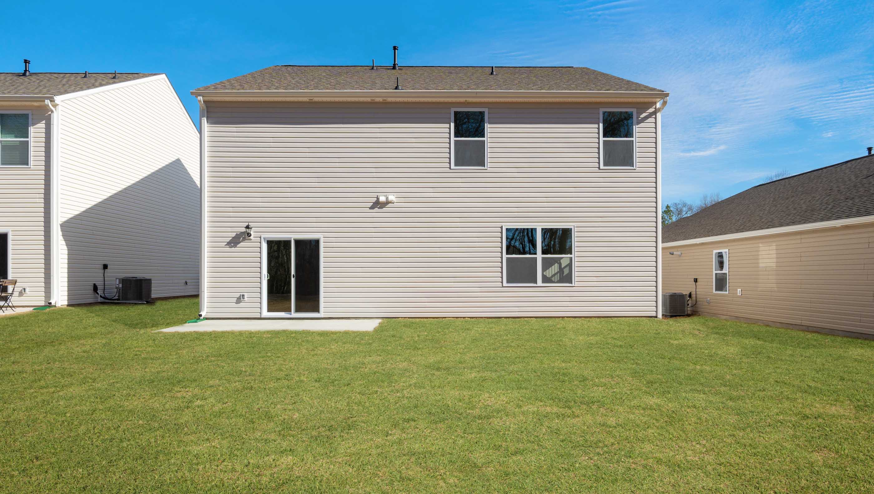 Back exterior with large backyard.