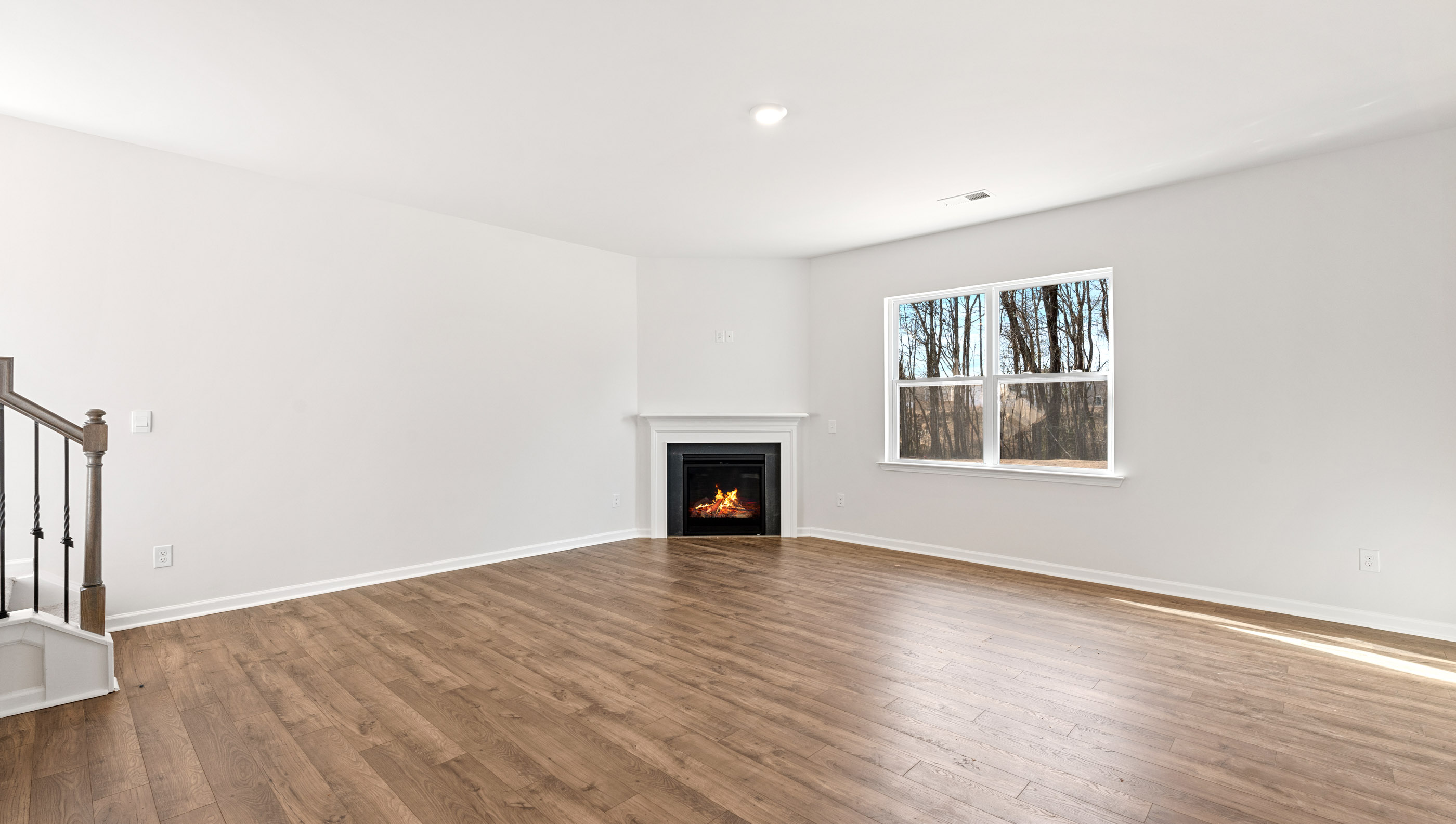 Living area with fireplace and windows.
