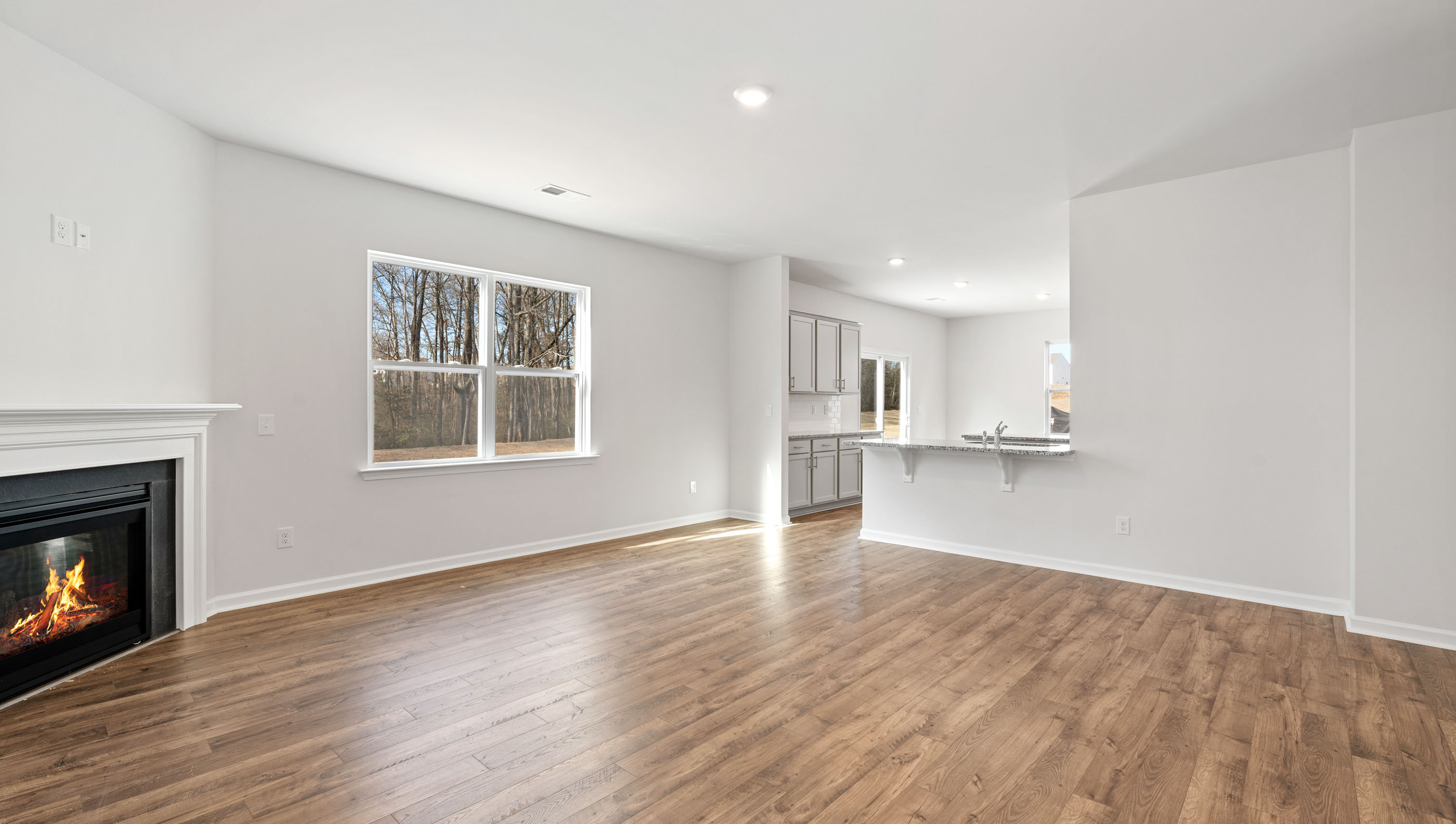Living area with fireplace and windows.