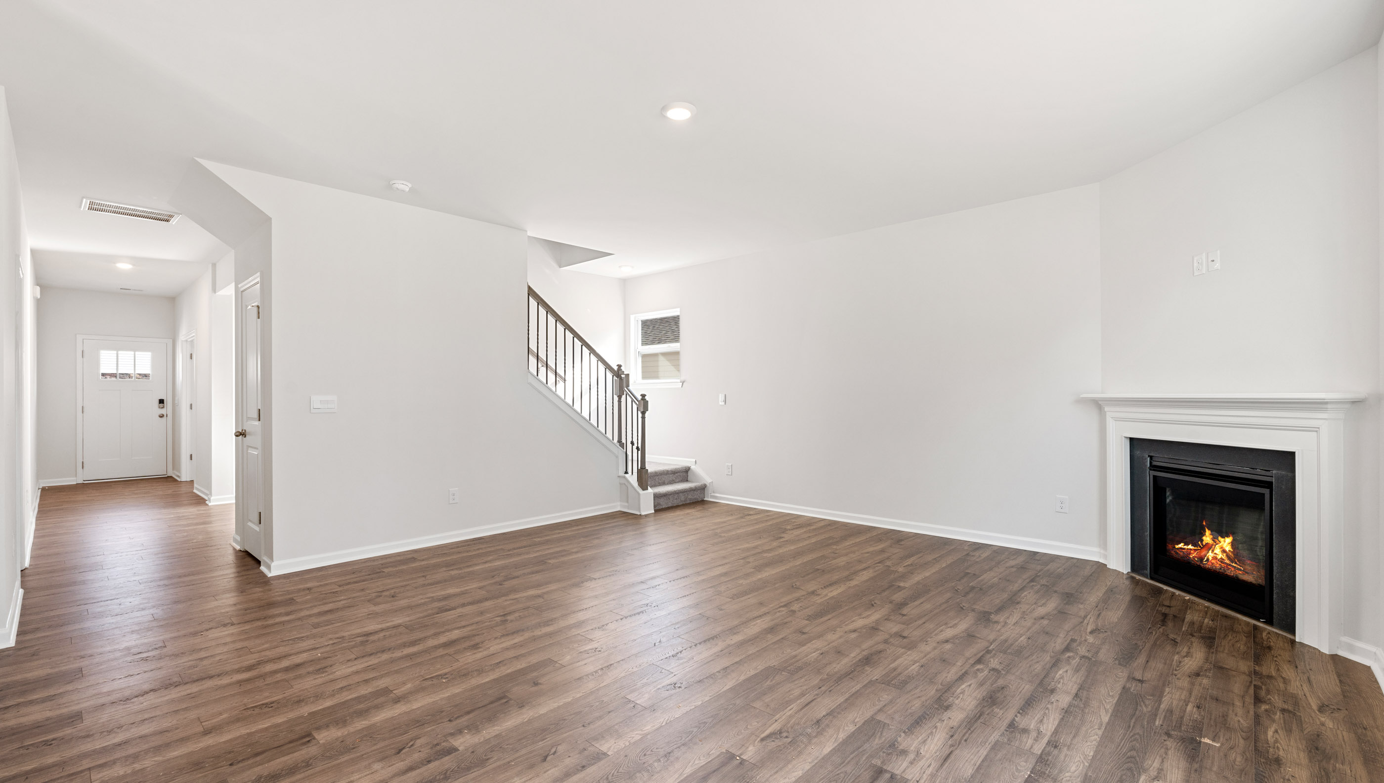 Living area with fireplace and windows.