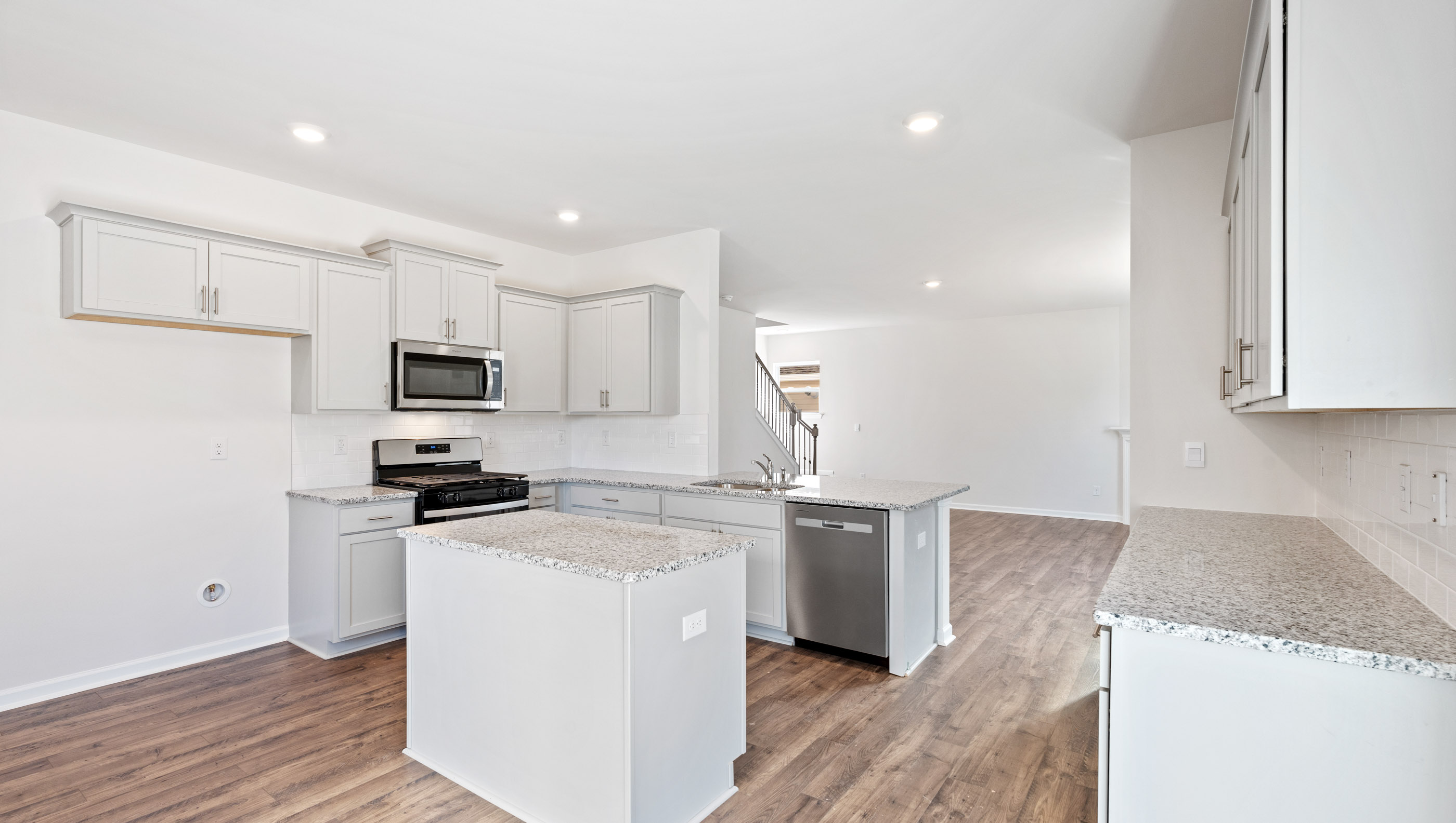 Kitchen with island and cabinets.