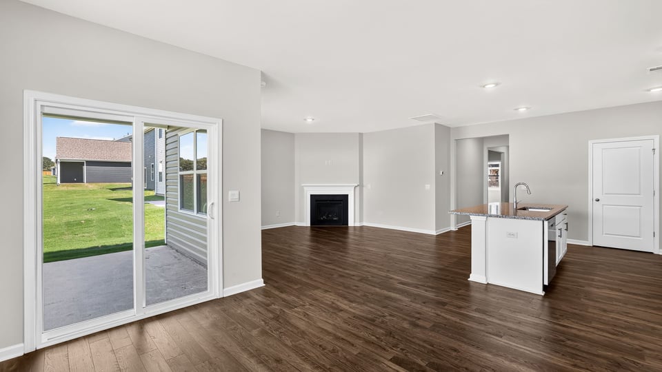 Living area with fireplace and windows.