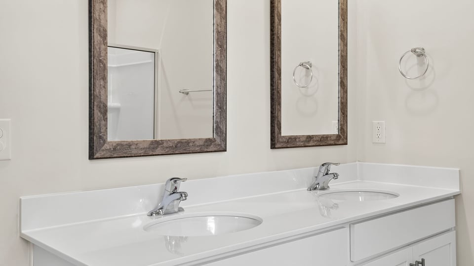 Primary bathroom with double vanity sinks.