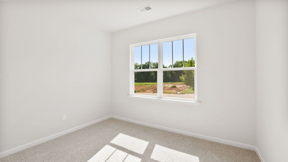 Bedroom with carpet and windows.