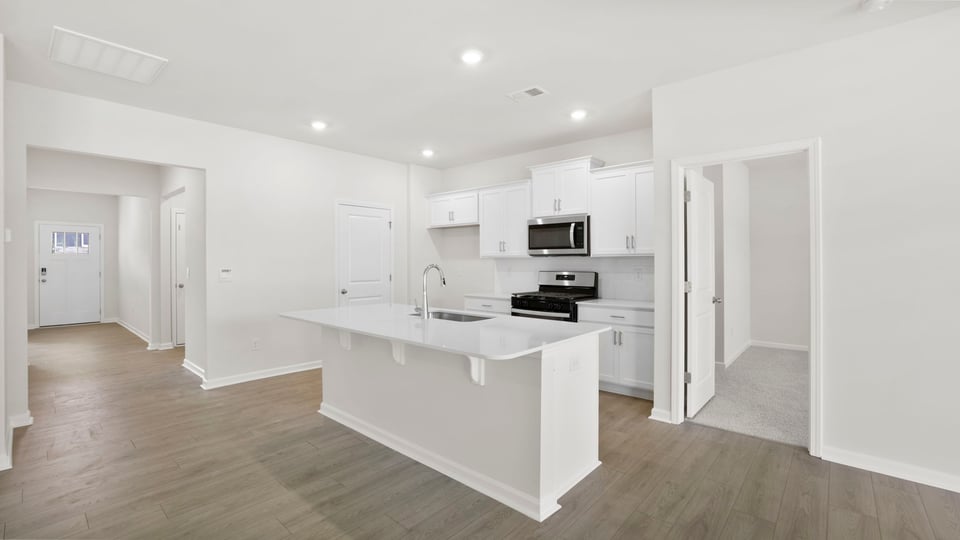 Kitchen with island and cabinets.
